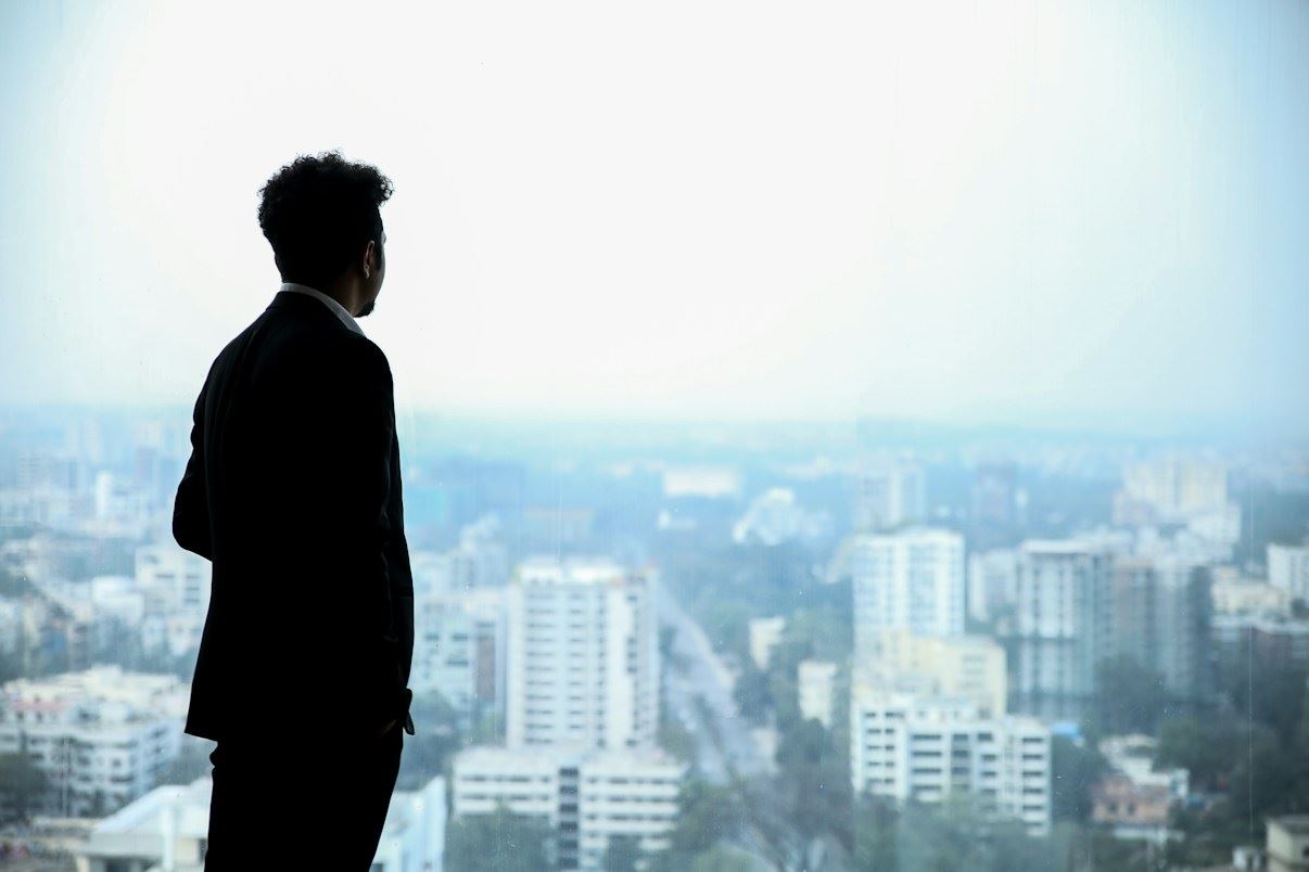 A businessman looking out over a city skyline