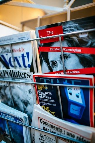 A rack of newspapers and magazines at a newsstand